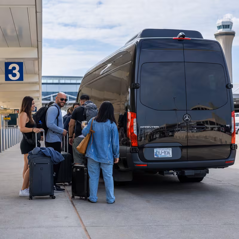Group boarding a white charter bus for Airport Transportation transportation in Oklahoma City