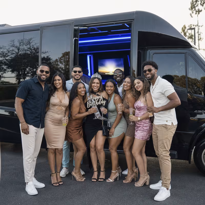 Group boarding a white charter bus for Birthday Transportation transportation in Oklahoma City