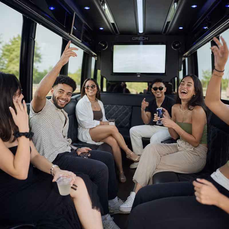 Group boarding a white charter bus for Concert Transportation transportation in Oklahoma City