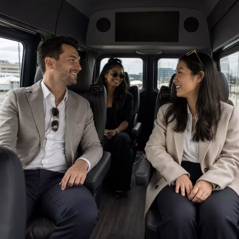 Group boarding a white charter bus for Corporate Transportation transportation in Oklahoma City