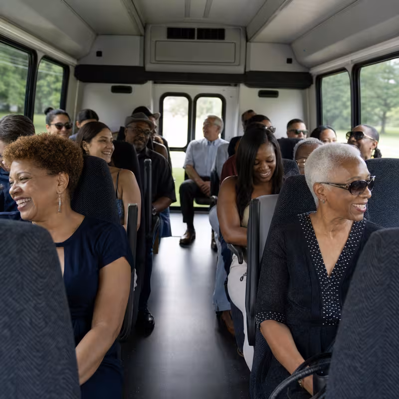 Group boarding a white charter bus for Private Event Transportation transportation in Oklahoma City