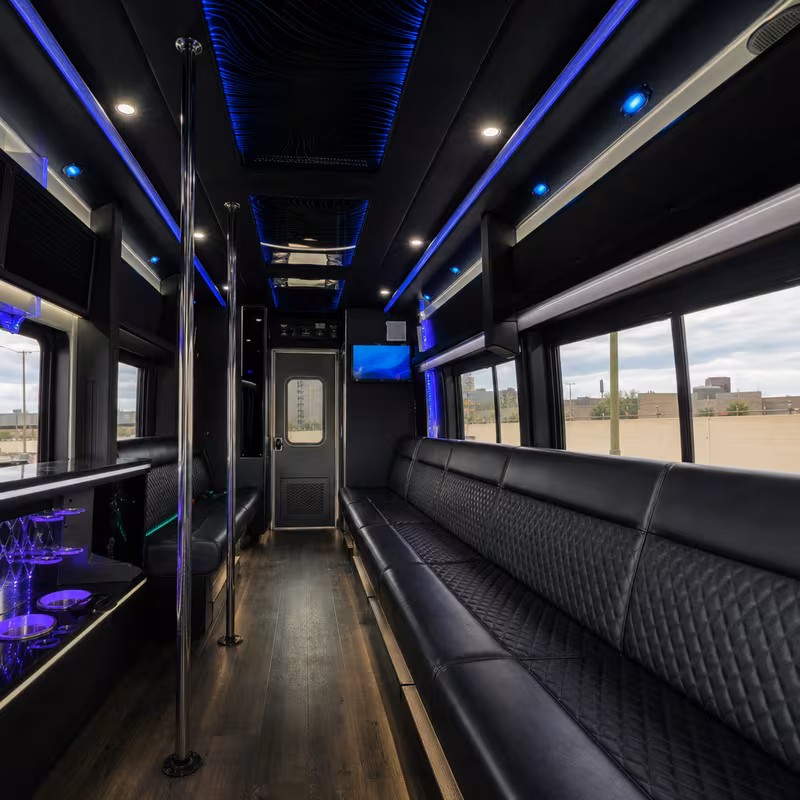 Party bus interior with wraparound leather seating and LED lighting in Oklahoma City