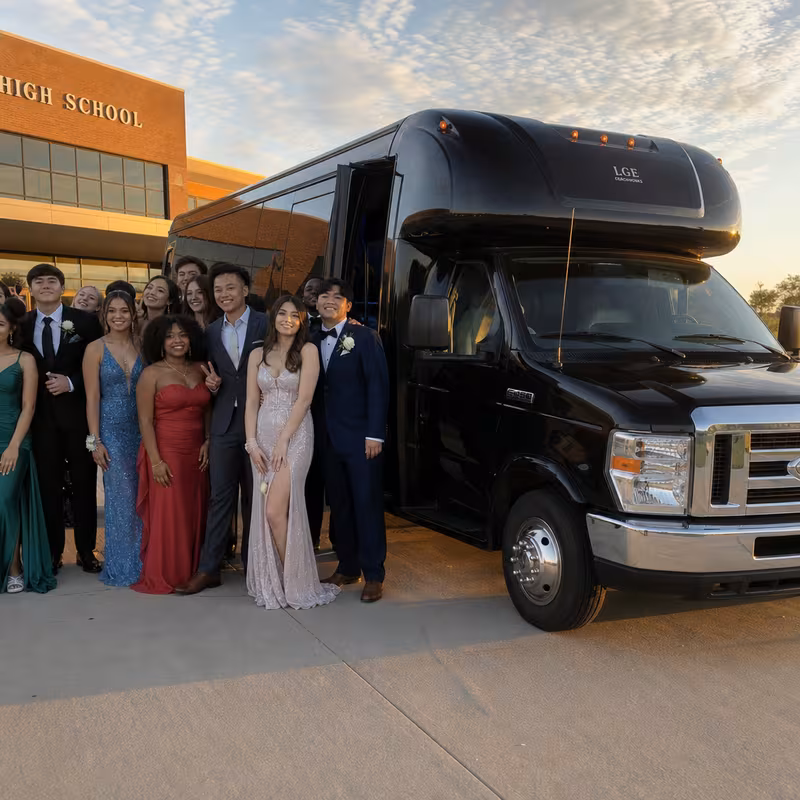 Group boarding a white charter bus for Prom & Homecoming Transportation transportation in Oklahoma City